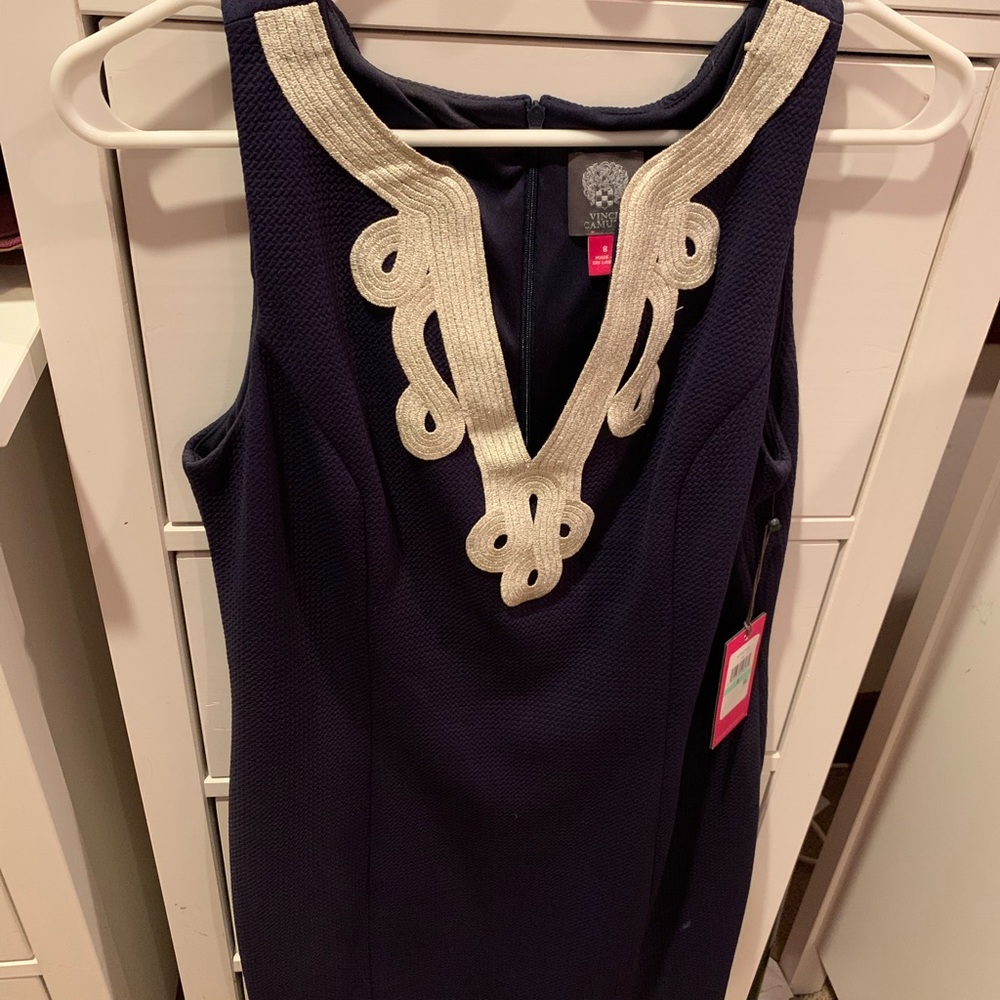 Navy blue just above the knee length fitted dress.